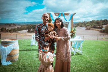 A joyful family gathering outdoors, with children creating lasting memories together