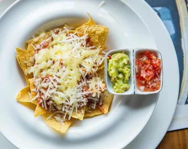 Mexican food nachos with sauce and cheese — Stok fotoğraf