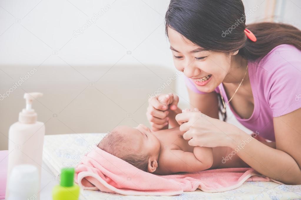 happy mother playing with her baby after being bahted