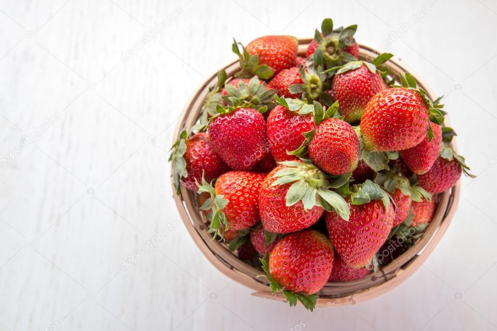 fresh strawberries in rattan basket