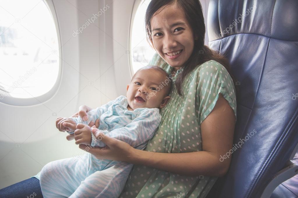 mother and baby sitting in airplane