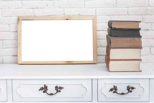 White board and stack of books on vintage desk table — Stock Photo, Image