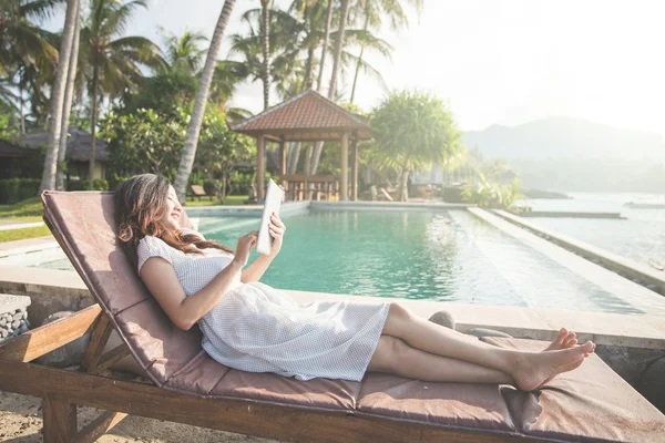 Žena relaxaci u bazénu a použití tabletu — Stock fotografie