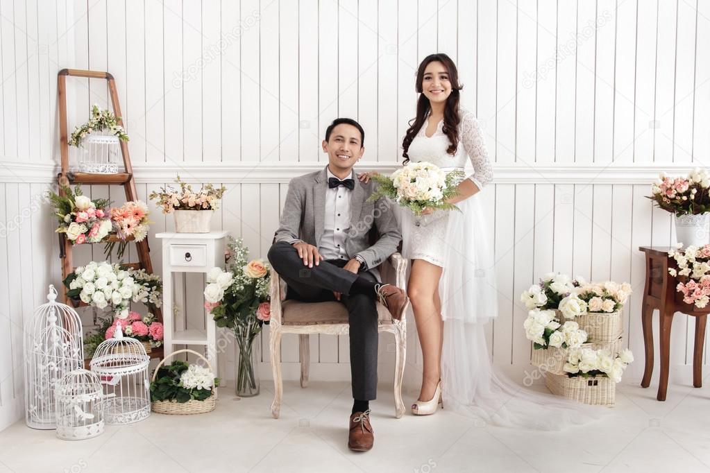 pre wedding photos of newlywed couple at decorated room