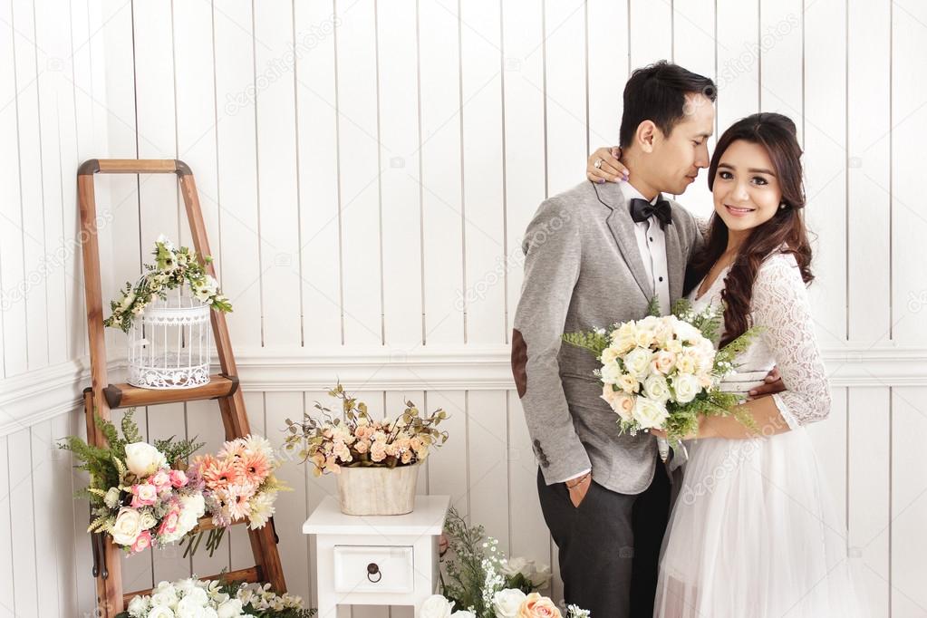 romantic newlywed couple at decorated room