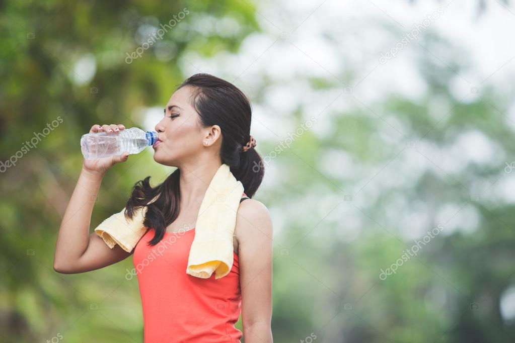 woman drinking water outdoor