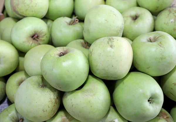 Green apples as background texture. Selective focus