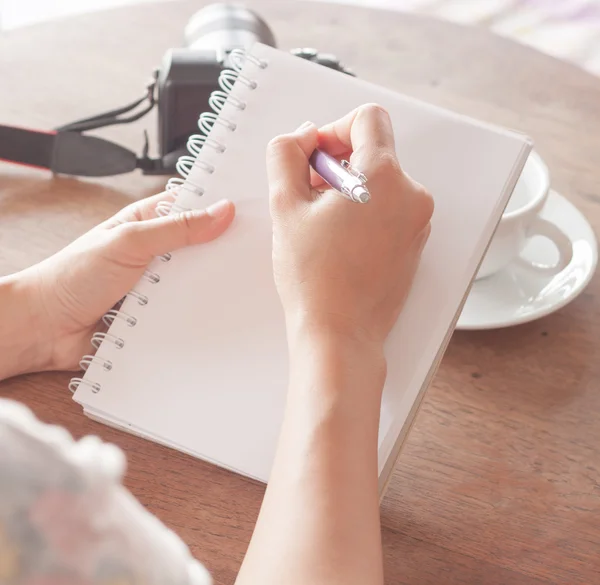 Mulher mão com caneta escrita no caderno — Fotografia de Stock
