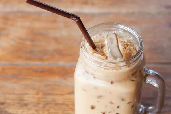 Glass of iced coffee on wooden table with vintage filter style — Stock Photo, Image