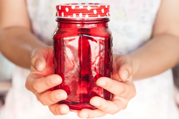 Woman's hand holding red glass — Stock Photo, Image