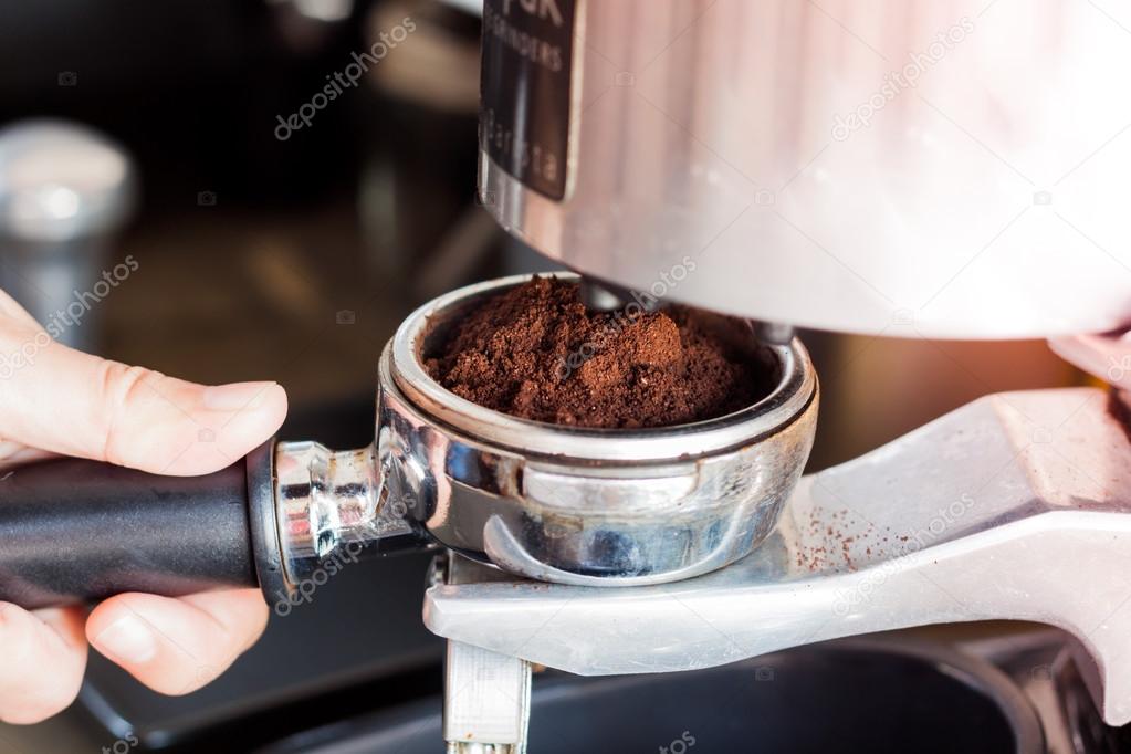 Woman's hand holding coffee grind in group with vintage style