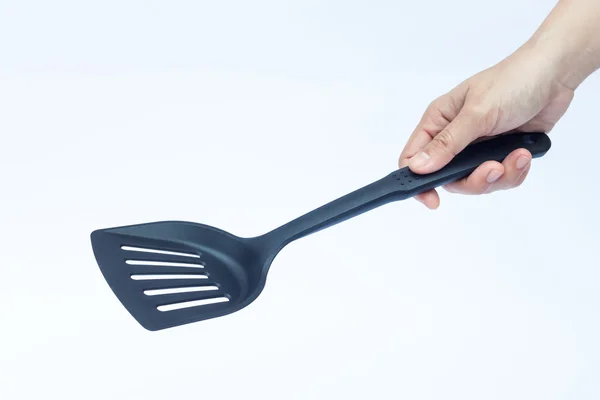 Schwarzer Kunststoff-Küchenspachtel auf weißem Hintergrund — Stockfoto