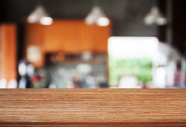 Parte superior de madera con fondo abstracto desenfoque cafetería — Foto de Stock