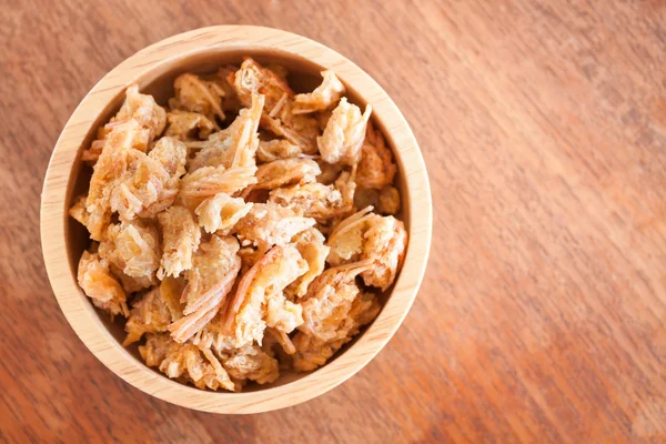 Fried shrimp chins snack in wooden bowl — Stock Photo, Image