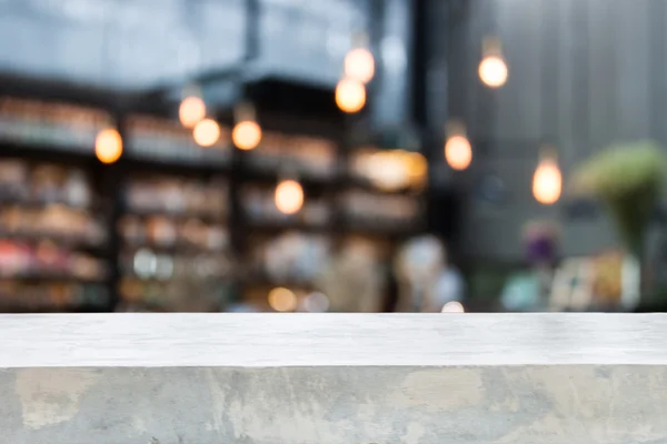 Betonnen tafelblad met coffeeshop achtergrond wazig — Stockfoto