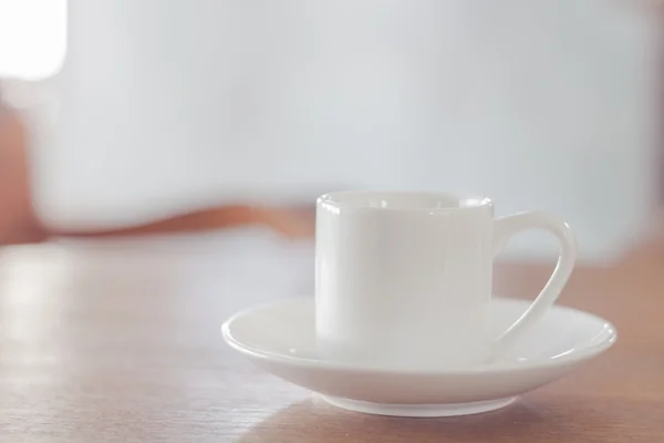 Mini white coffee cup on wooden table — Stock Photo, Image