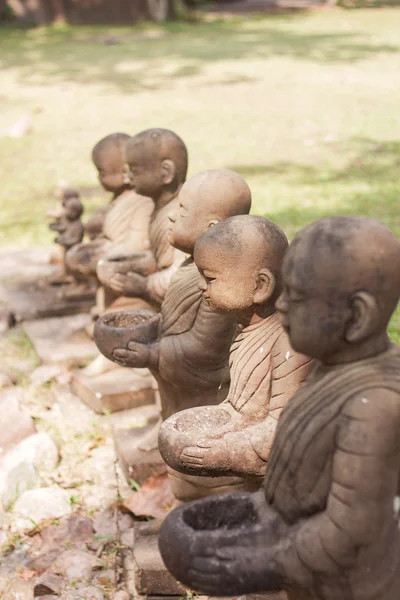 Little monk clay doll decorated in garden — Stock Photo, Image