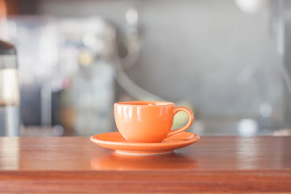 Mini orange coffee cup in coffee shop — Stock Photo, Image