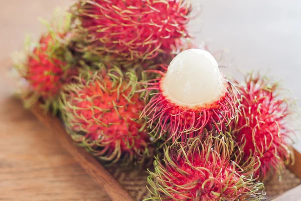 Fresh rambutans on wodden tray — Stock Photo, Image