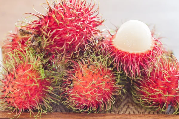 Fresh rambutans on wodden tray — Stock Photo, Image