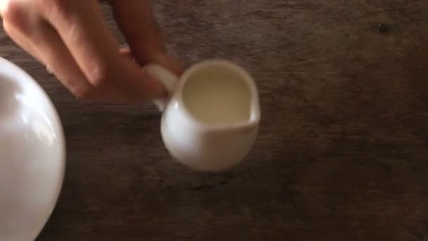 Pouring milk into coffee cup — Stock Video