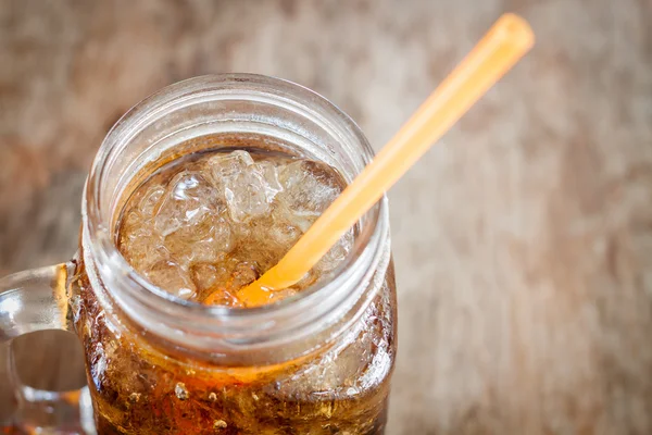 Glass of cola with ice on wooden table — Stock Photo, Image