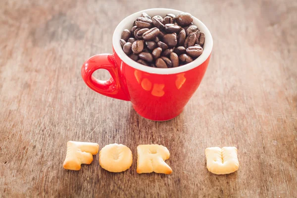 Pour u alphabet biscuit avec tasse de café rouge — Photo