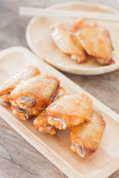 Grilled chicken wings on wooden plate — Stock Photo, Image