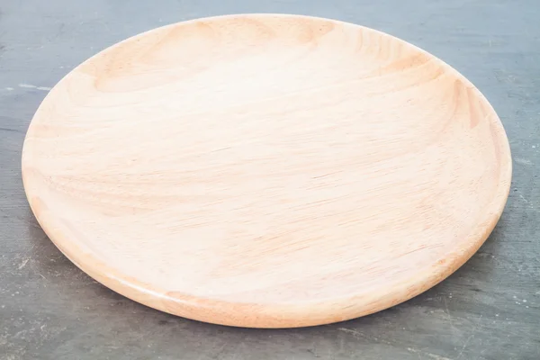 Wooden plate on grey background — Stock Photo, Image