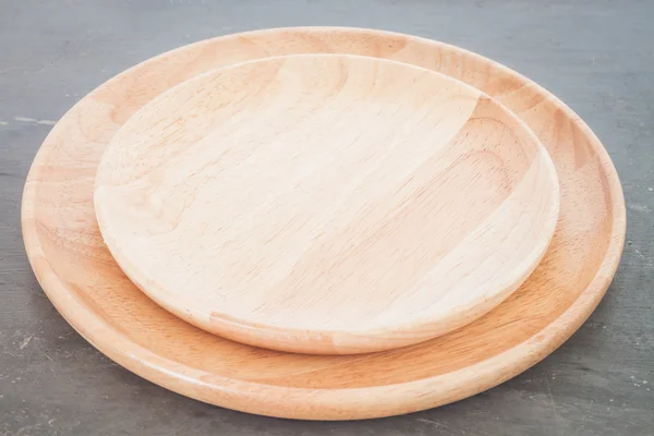 Wooden plate on grey background — Stock Photo, Image