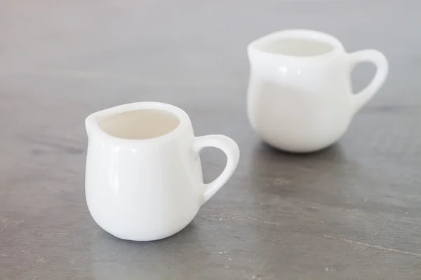 White ceramic pitcher on grey background — Stock Photo, Image