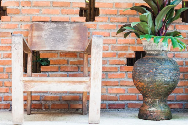 Chaise en bois avec mur de briques rouges — Photo