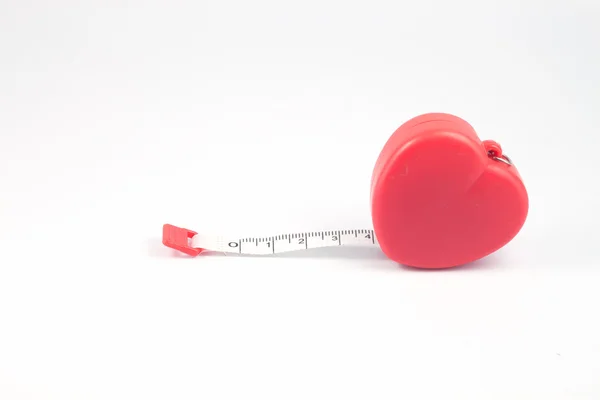 Measuring tape in heart shape on white background — Stock Photo, Image