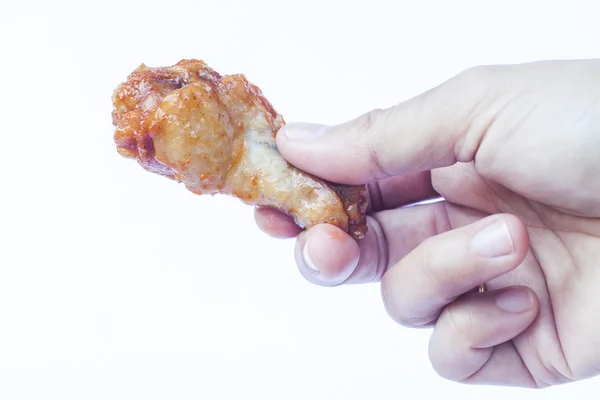 Hand holding grilled chicken wing isolated on white background — Stock Photo, Image