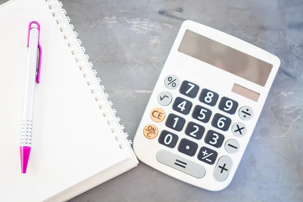 Calculator, notepad and pen on grey background — Stock Photo, Image