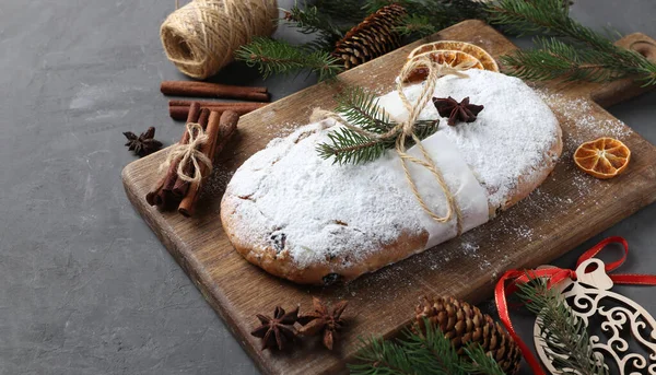 Christmas tasty stollen with dry fruits, berries and nuts on wooden board. Traditional German treats. — Stock Photo, Image