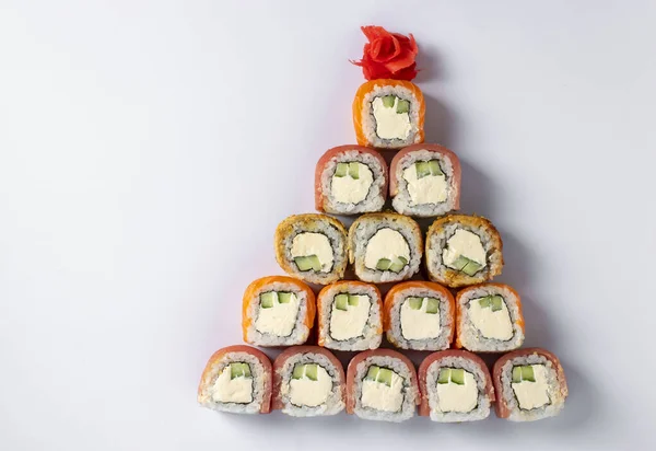 Jadalne choinki z sushi z łososiem, tuńczykiem i węgorzem z serem filadelfijskim na białym. Przyjęcie noworoczne. Miejsce na tekst. Widok z góry — Zdjęcie stockowe