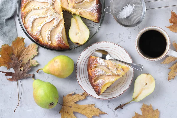 Pie with pears, cup of coffee and fresh pears on light gray background. Autumn still life. Top view
