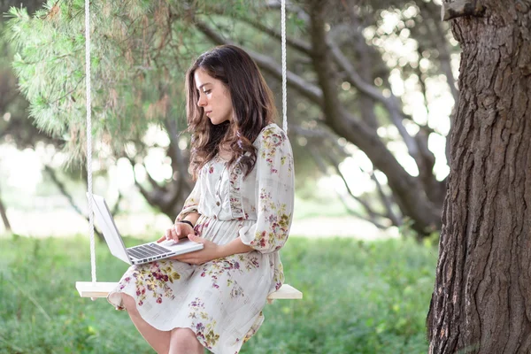 Woman with Laptop on a Swing — Stock Photo, Image