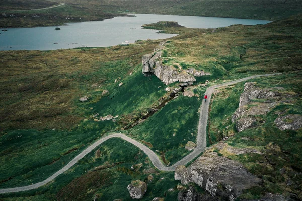 Man hiking at  Lake Toftavatn on hiking trail from above, Runavik, island Eysturoy, Faroe Islands