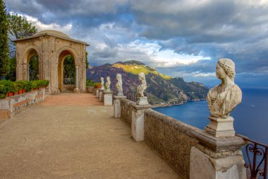 Amazing scene with ancient statues  and fantastic landscape  on Cimbrone  villa . Amalfo coast. clipart