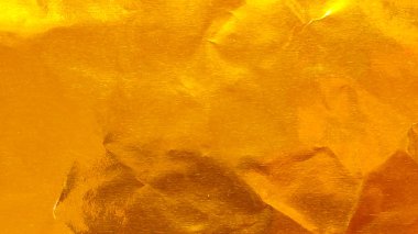 Parlak Buruşuk Altın folyo dokusu Kırışıklıklar ve Lüks Kutlamalar ve Soyut Tasarım İçin Katlar Arkaplanı