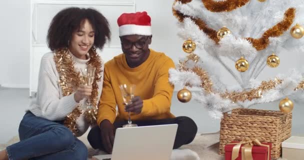 Isolated afro american family celebrating Christmas remotely talking with friends in video chat drinking champagne congratulating online saying into laptop webcam, new year 2021 during covid pandemic — Stock Video