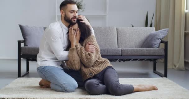 Caring husband caucasian male boyfriend consoles crying african american woman wife girlfriend support hugs. Girl feels sadness upset stress suffers from breaking up quarrel, family couple concept — Stock Video