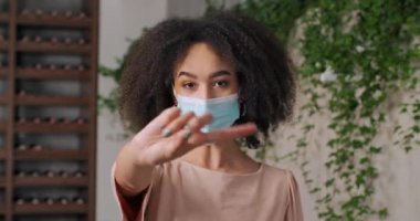 Portrait of afro american angry sad mixed race girl ethnic masked woman unhappy feeling rage stress resentment showing finger no stop sign prohibits approach denies shaking finger, disapproval concept