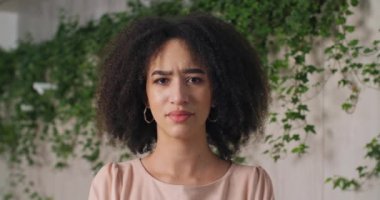Front portrait of disgruntled african american woman with stylish curls looking at camera sadly shakes her head to sides unanimously denies prohibits says no, angry girl refuses frowns on female face