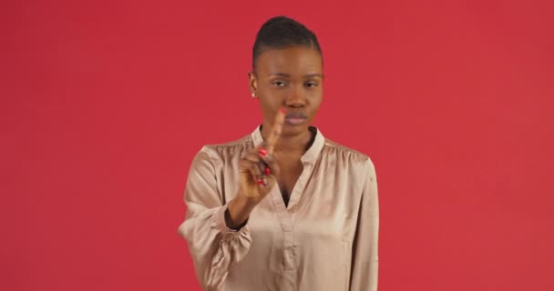 Studio portrait afro american woman black mixed race girl standing on red background shaking her finger and head negatively disagreeing sign gesture prohibition denial discontent says no body language — Stock Video