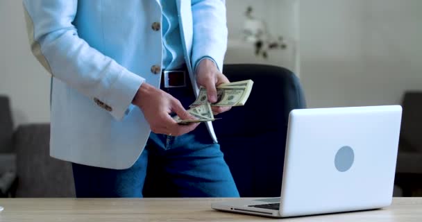 Mężczyzna ręce trzymając stos pieniędzy, licząc banknoty dolara z ich palcami podczas stojąc w pobliżu biurka w domu biurowym w biznes klasyczny garnitur, planuje inwestycję, otrzymuje nagrodę, zamożność koncepcji sukcesu — Wideo stockowe