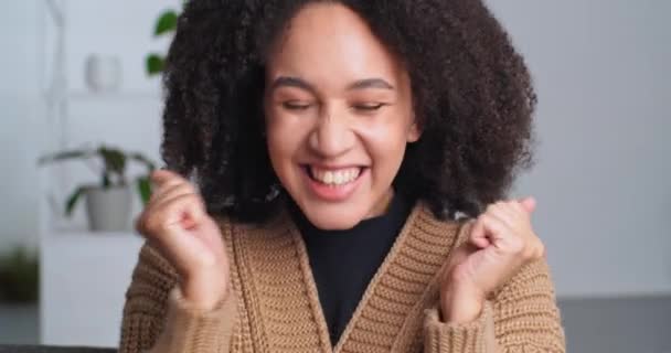Portrait of emotional African American girl woman feeling joy delight enjoying good news victory triumph success learns about good exam score gets job offer opportunity applauds claps shouts says yes — Stock Video