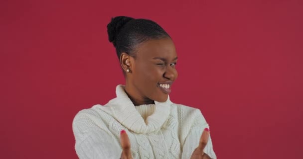 Happy ethnic model african american woman stands isolated on red background posing showing thumbs up demonstrates gesture of success support triumph victory rejoices smiling dancing looking at camera — Stock Video